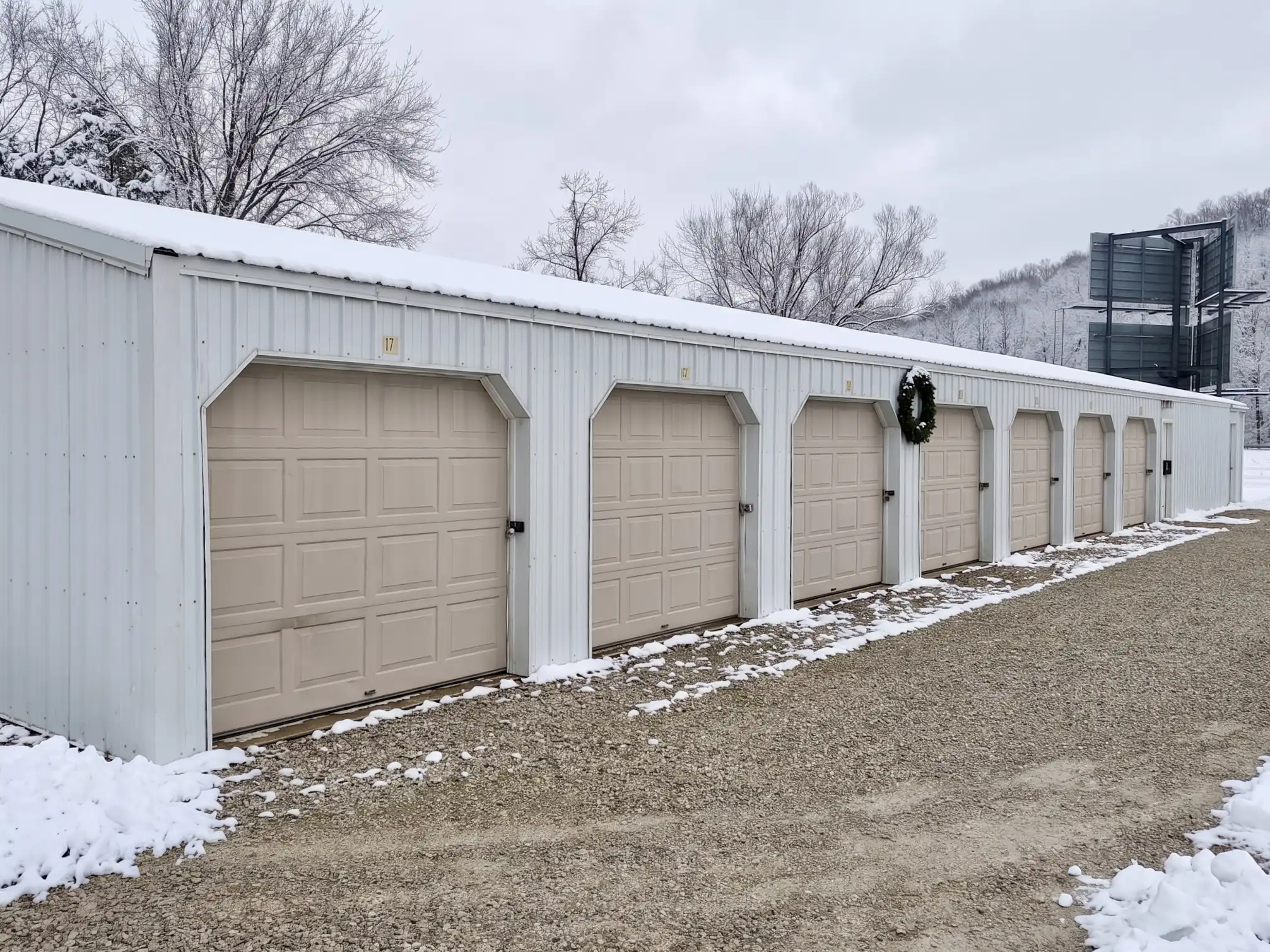 Row of tan storage unit doors at GSG Self Storage with room to park
